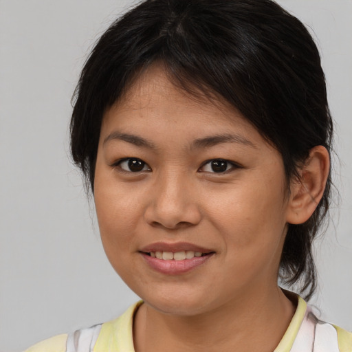 Joyful asian young-adult female with medium  brown hair and brown eyes