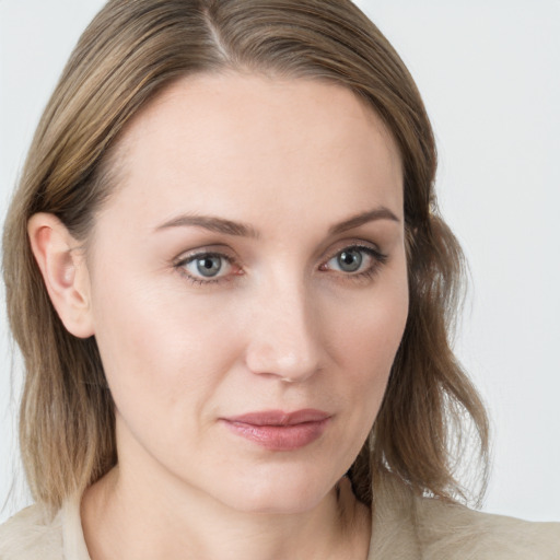 Joyful white young-adult female with medium  brown hair and blue eyes