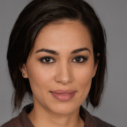 Joyful white young-adult female with medium  brown hair and brown eyes