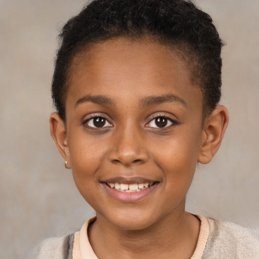 Joyful black child female with short  brown hair and brown eyes