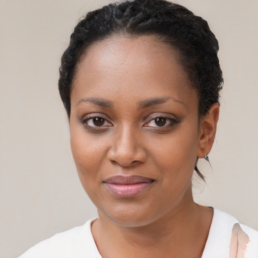 Joyful black young-adult female with short  black hair and brown eyes