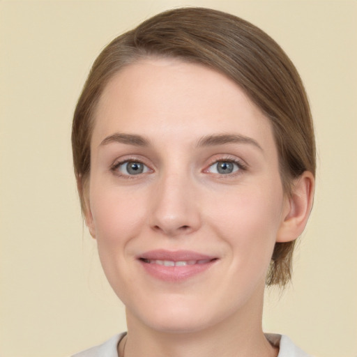 Joyful white young-adult female with medium  brown hair and green eyes