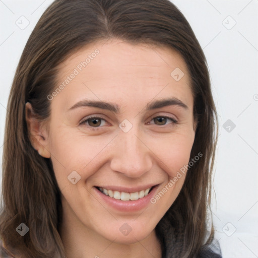 Joyful white young-adult female with long  brown hair and brown eyes