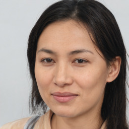 Joyful white adult female with long  brown hair and brown eyes