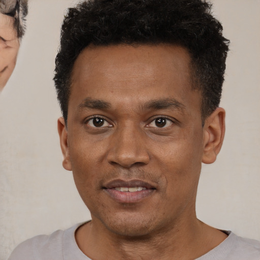 Neutral black young-adult male with short  black hair and brown eyes