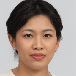 Joyful asian young-adult female with short  brown hair and brown eyes