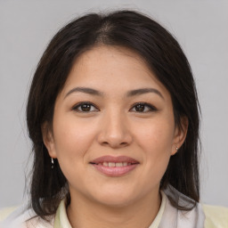 Joyful latino young-adult female with medium  brown hair and brown eyes