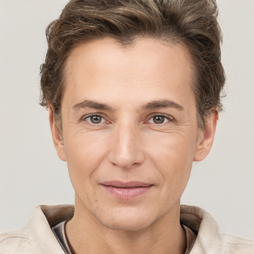 Joyful white adult male with short  brown hair and grey eyes