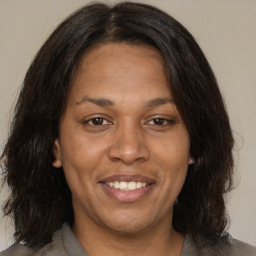 Joyful black adult female with medium  brown hair and brown eyes