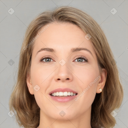 Joyful white young-adult female with medium  brown hair and green eyes