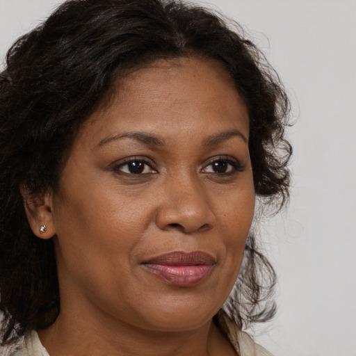 Joyful black adult female with medium  brown hair and brown eyes
