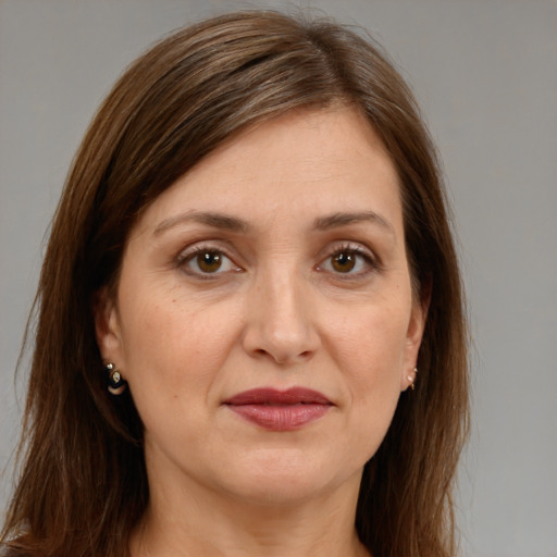 Joyful white adult female with long  brown hair and brown eyes