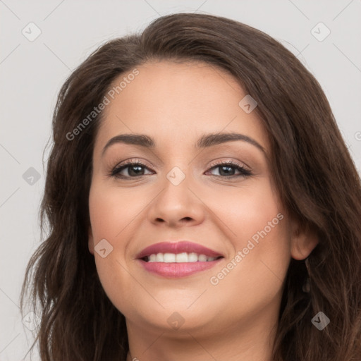 Joyful white young-adult female with long  brown hair and brown eyes