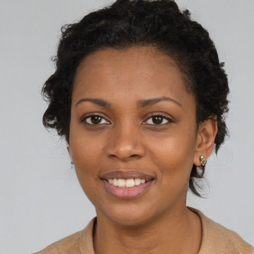 Joyful black young-adult female with short  brown hair and brown eyes