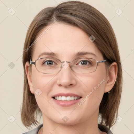 Joyful white adult female with medium  brown hair and grey eyes