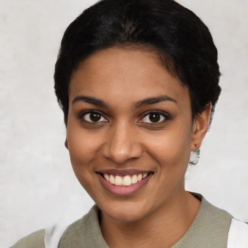 Joyful latino young-adult female with short  black hair and brown eyes