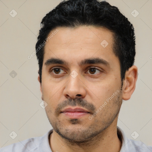 Neutral latino young-adult male with short  black hair and brown eyes