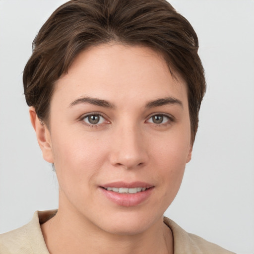 Joyful white young-adult female with short  brown hair and brown eyes