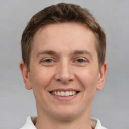 Joyful white young-adult male with short  brown hair and brown eyes