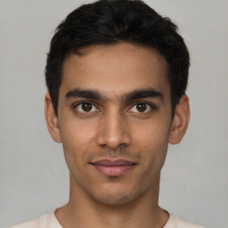 Joyful latino young-adult male with short  brown hair and brown eyes