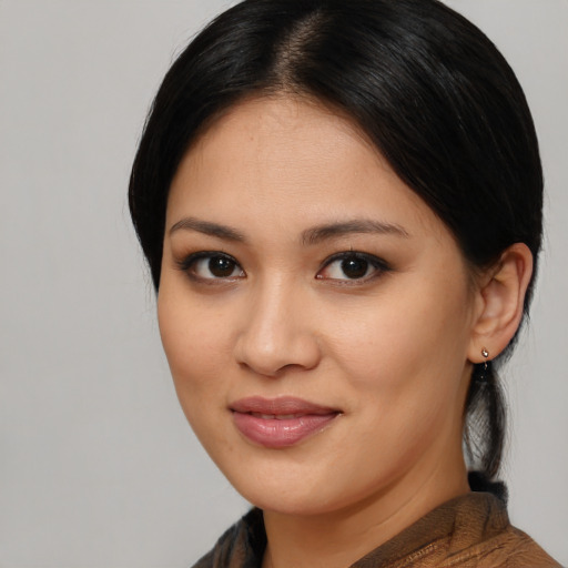 Joyful latino young-adult female with medium  brown hair and brown eyes
