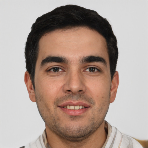 Joyful white young-adult male with short  black hair and brown eyes