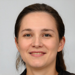 Joyful white young-adult female with medium  brown hair and grey eyes