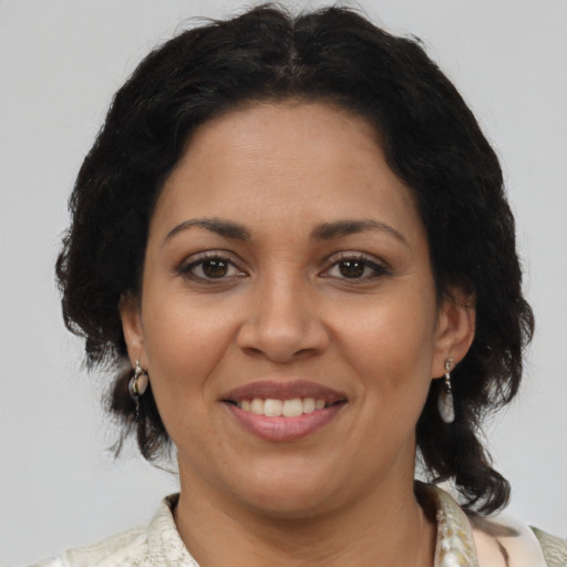 Joyful latino adult female with medium  brown hair and brown eyes