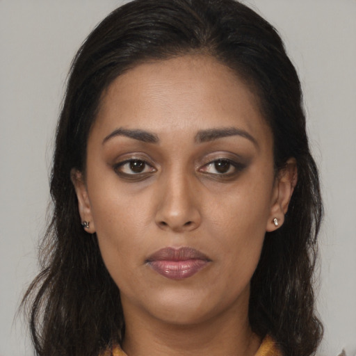 Neutral latino young-adult female with long  brown hair and brown eyes
