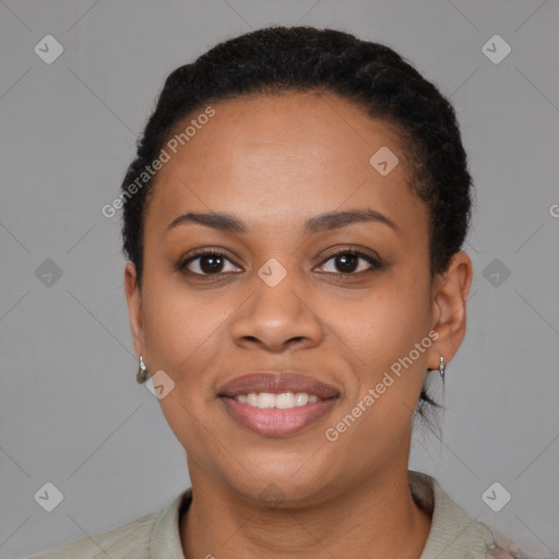 Joyful black young-adult female with short  black hair and brown eyes