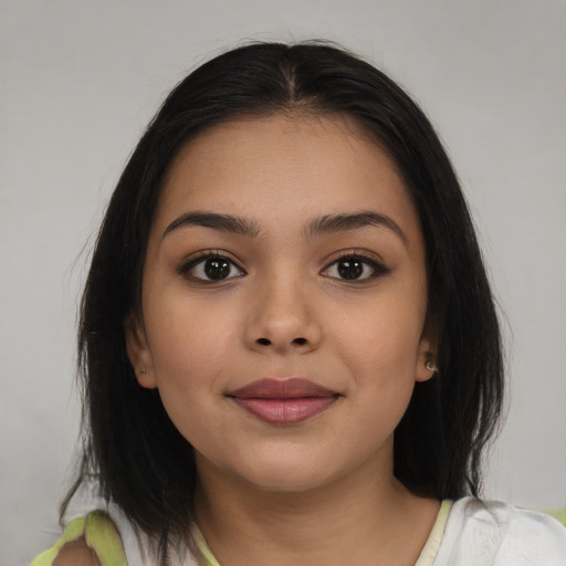 Joyful latino young-adult female with medium  brown hair and brown eyes