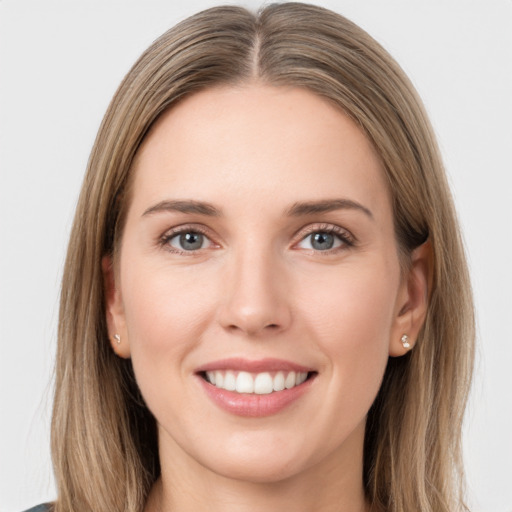 Joyful white young-adult female with long  brown hair and grey eyes