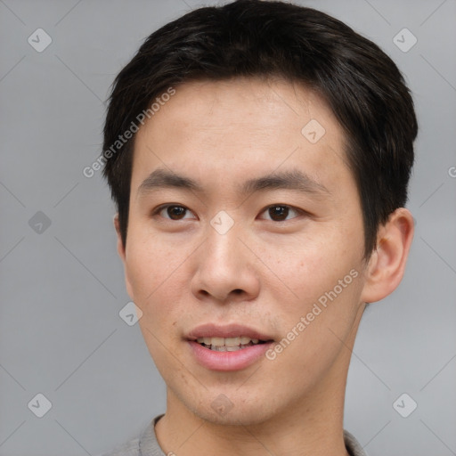 Joyful asian young-adult male with short  brown hair and brown eyes