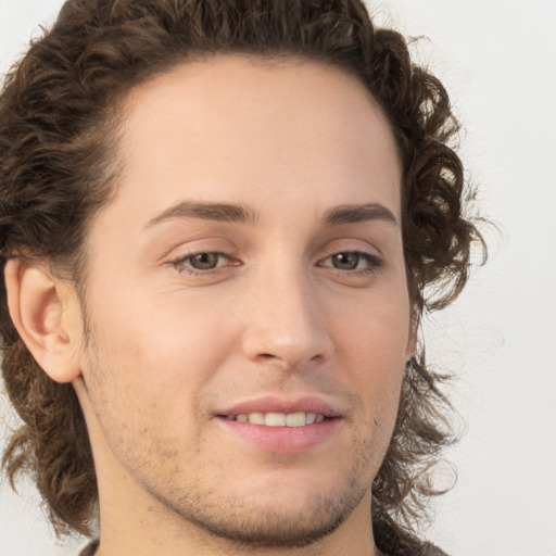 Joyful white young-adult male with medium  brown hair and brown eyes