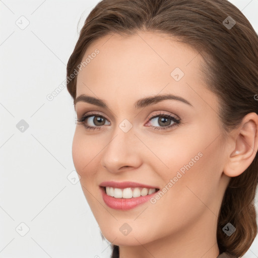 Joyful white young-adult female with long  brown hair and blue eyes