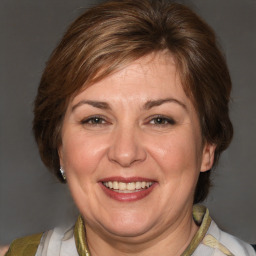 Joyful white adult female with medium  brown hair and brown eyes