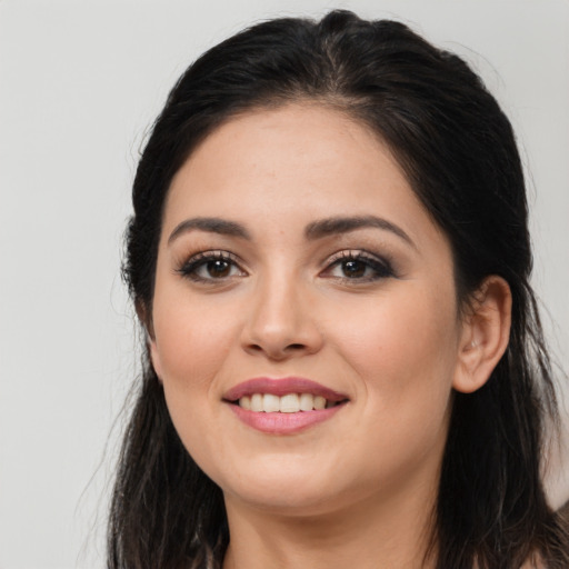 Joyful white young-adult female with long  brown hair and brown eyes