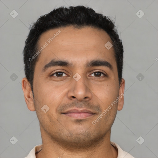 Joyful latino young-adult male with short  brown hair and brown eyes