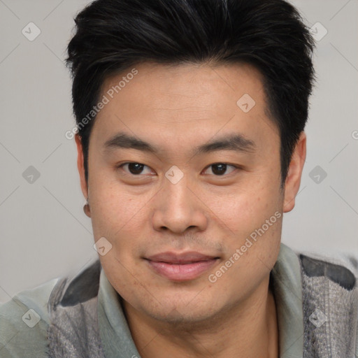 Joyful asian young-adult male with short  brown hair and brown eyes