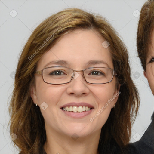 Joyful white adult female with long  brown hair and blue eyes