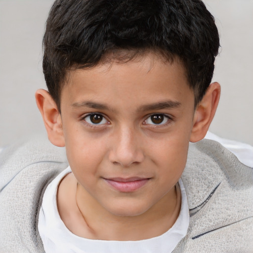 Joyful white child male with short  brown hair and brown eyes