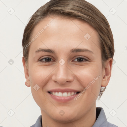 Joyful white young-adult female with short  brown hair and grey eyes