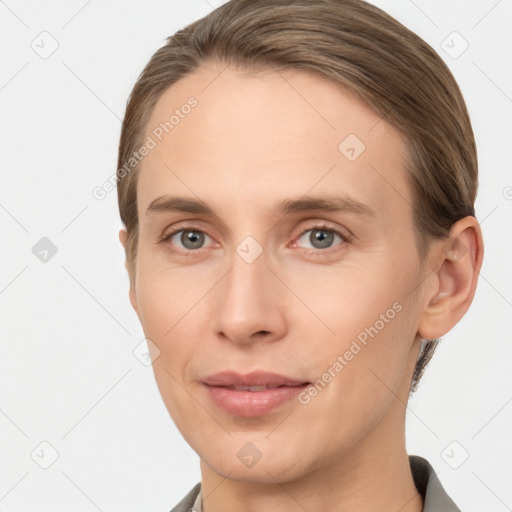 Joyful white young-adult female with short  brown hair and grey eyes