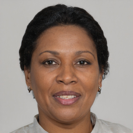 Joyful black adult female with short  brown hair and brown eyes