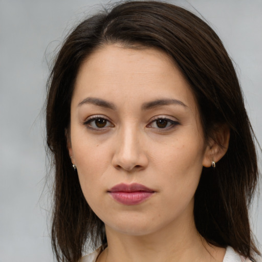 Joyful white young-adult female with long  brown hair and brown eyes