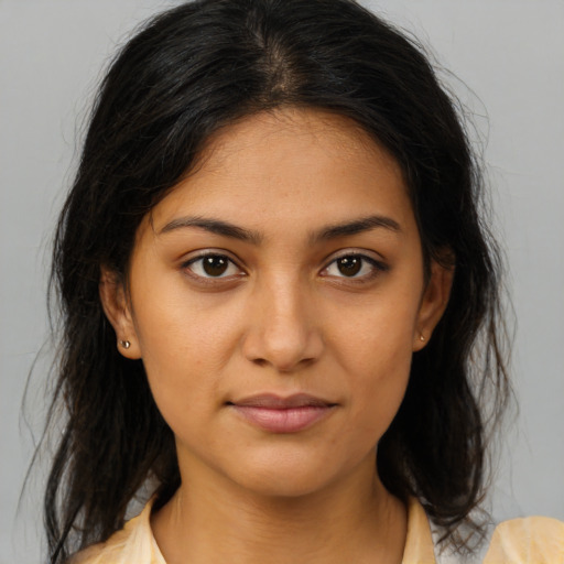 Joyful latino young-adult female with medium  brown hair and brown eyes