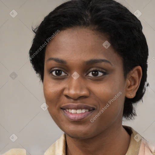 Joyful black young-adult female with short  black hair and brown eyes