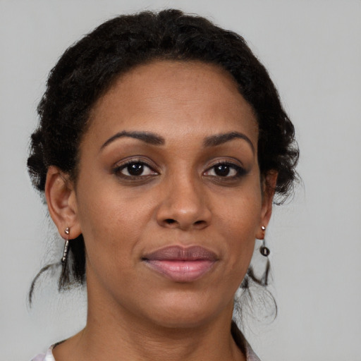 Joyful black young-adult female with medium  brown hair and brown eyes