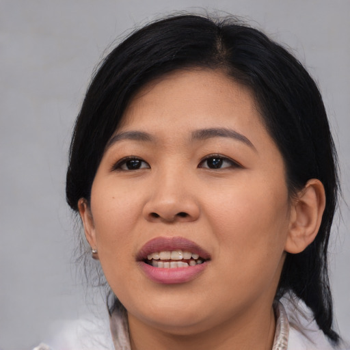 Joyful asian young-adult female with medium  black hair and brown eyes