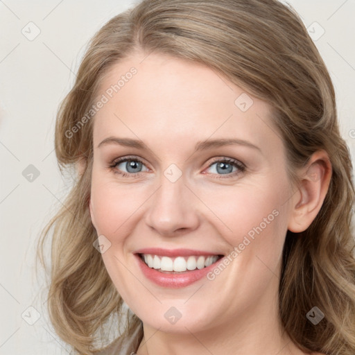 Joyful white young-adult female with long  brown hair and blue eyes